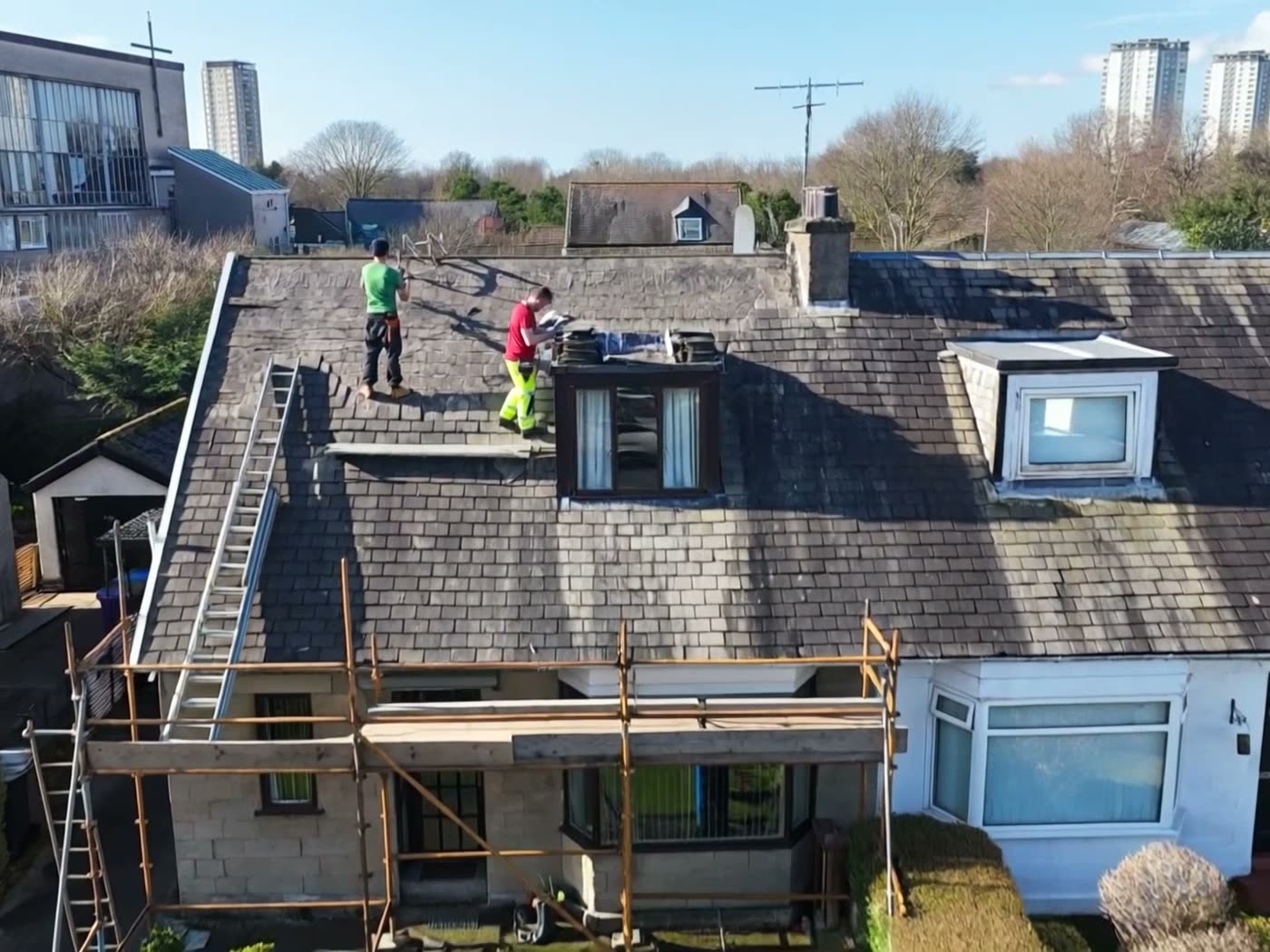 E Stewart Roofing team stripping a roof from the scaffold