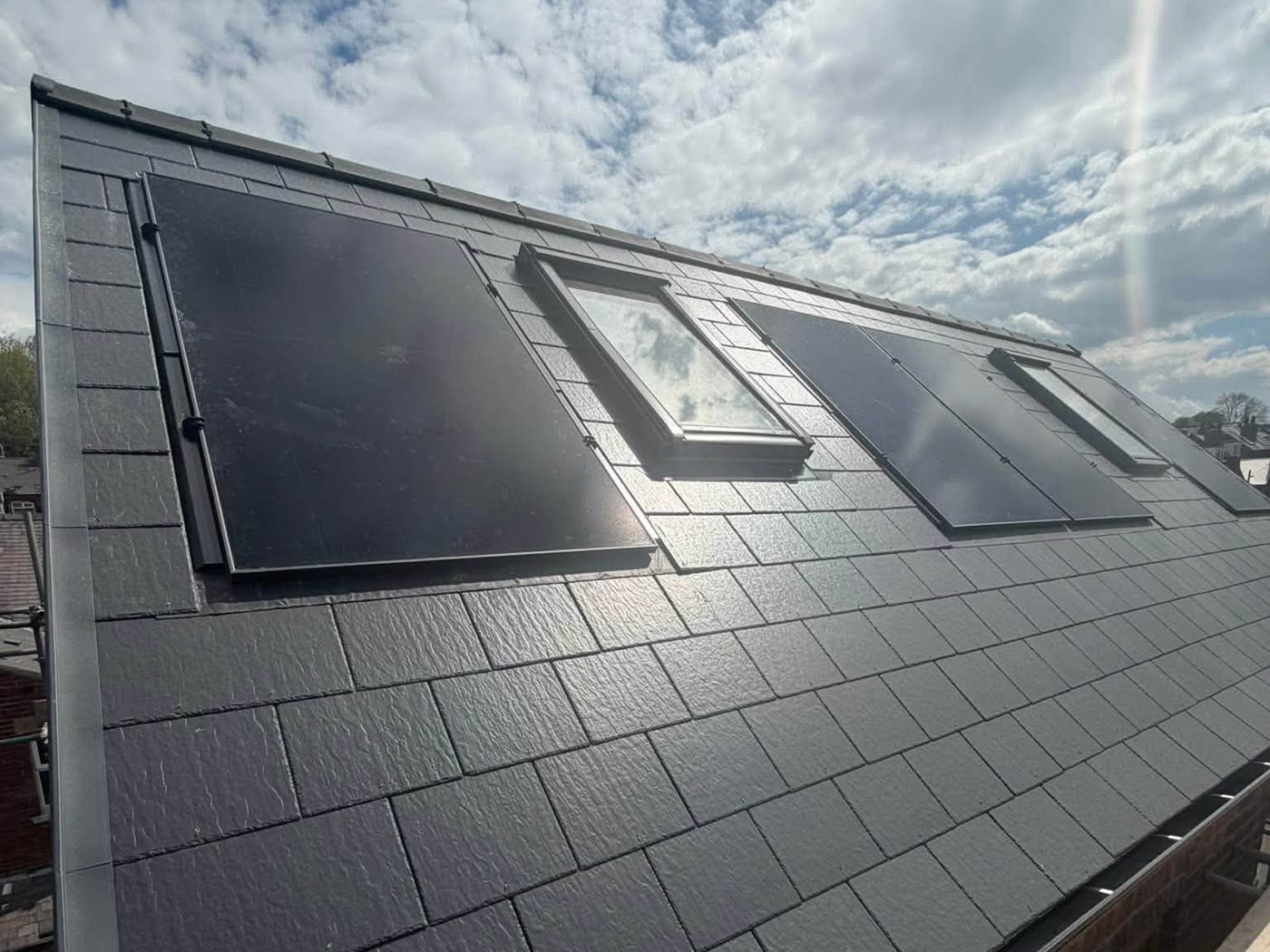 Slate laid around roof windows with lead detailing