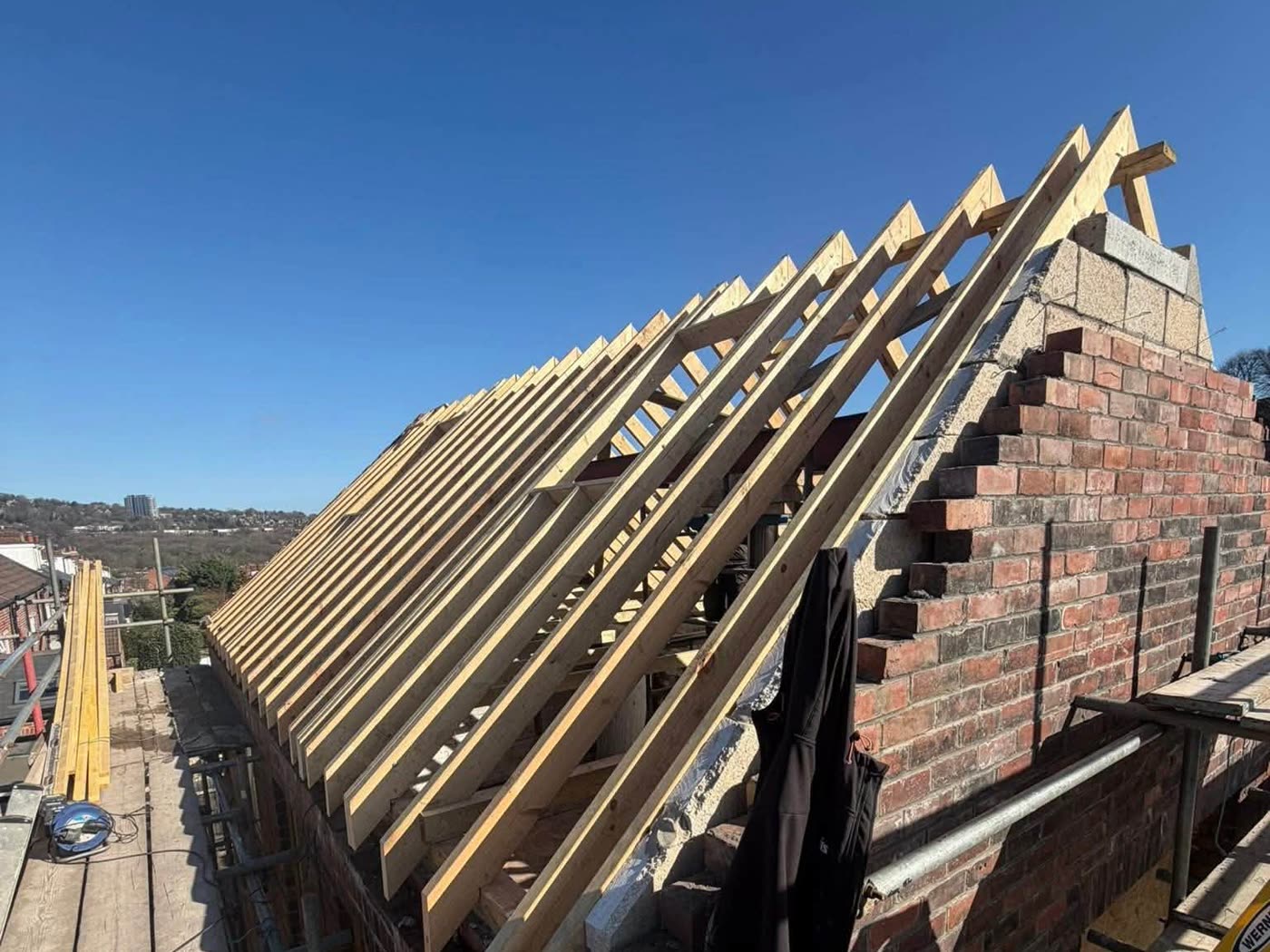 New rafters cut and set out over a rebuilt gable