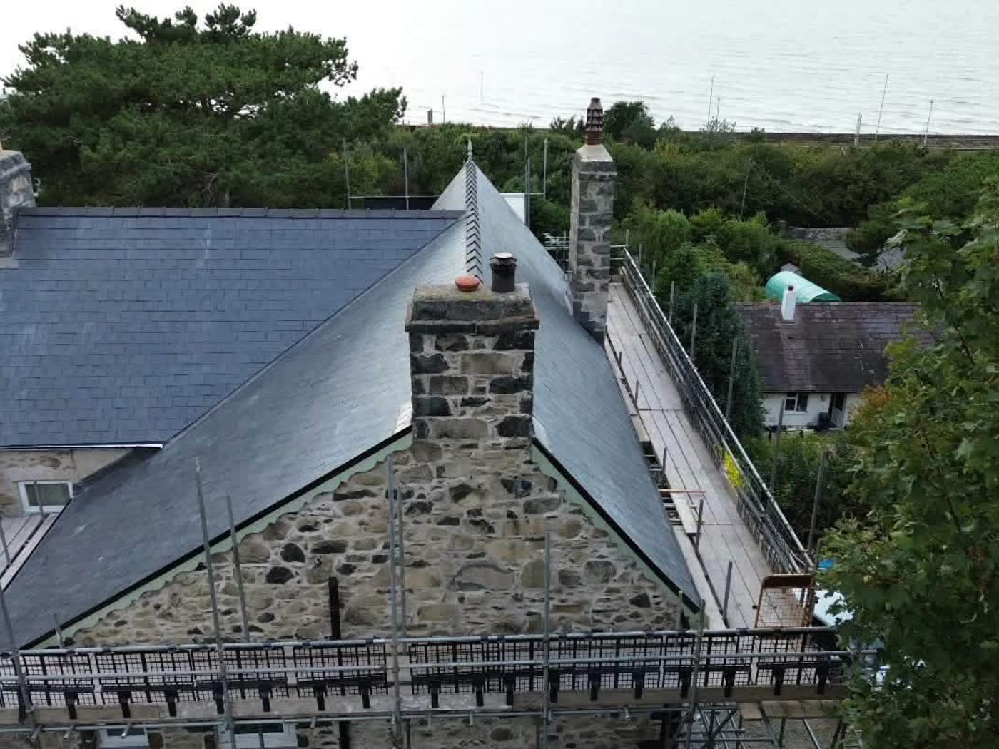 Traditional stone property with a natural slate roof and stone chimney stacks