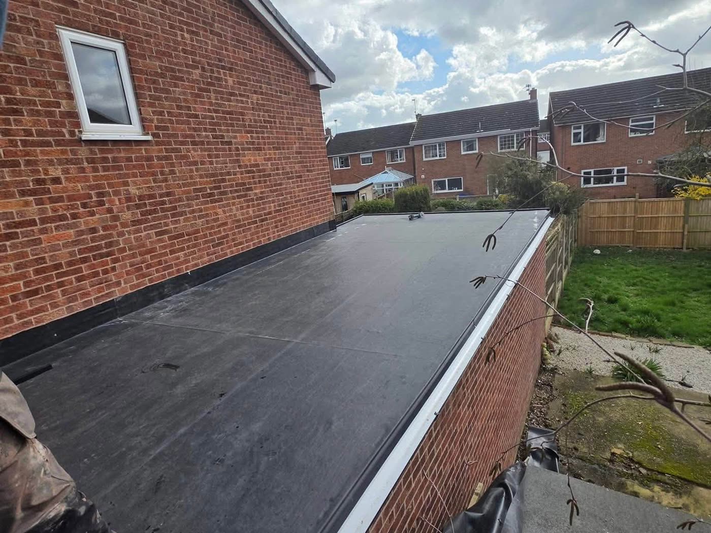 New single ply flat roof membrane laid across a rear extension
