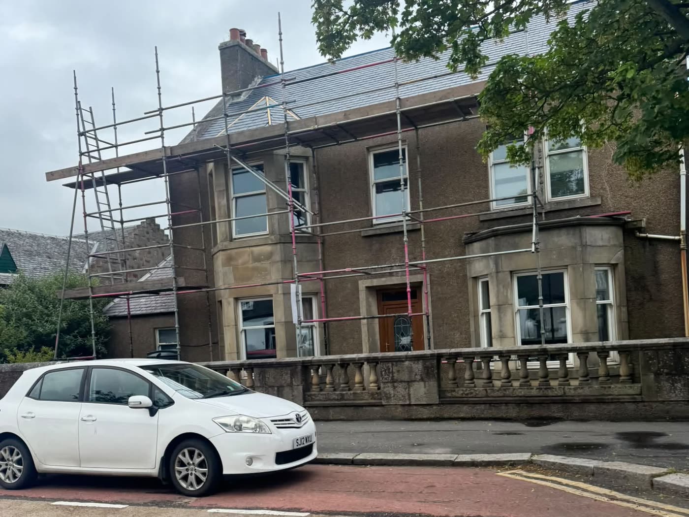 Scaffolding up on a traditional stone villa during a full re-roof