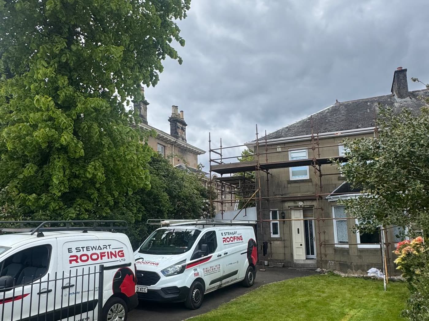 Traditional roughcast property with scaffolding up during external work